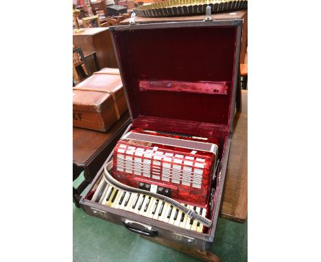 A Bellini red marble effect Piano Accordion, with travelling case