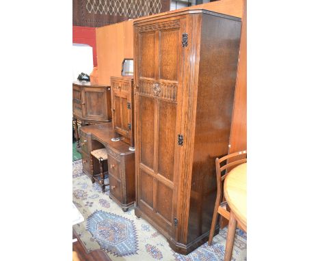 An oak hall robe; an oak pot cupboard; an oak dressing table; a stool (4)