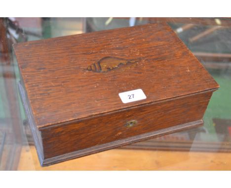 An early 20th century oak musical box, hinged cover inlaid with a shell patera, enclosing a lift out tray, the Swiss movement