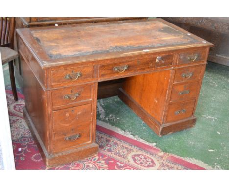 An Edwardian oak twin pedestal desk, circa 1910