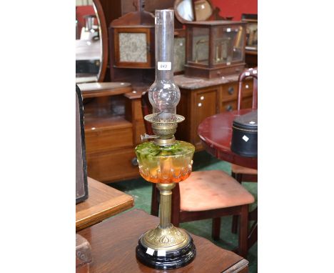 A Victorian brass oil lamp, moulded glass reservoir, with clear glass chimney