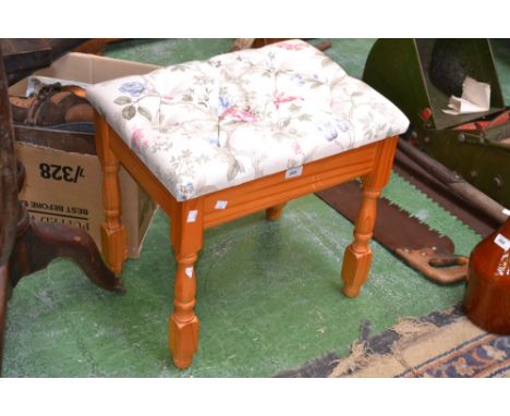 A pine stool with floral upholstered seat