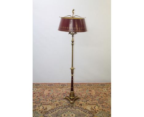 Regency-style brass standard lamp with toleware shade with slender lamp with fluted and figural ornament, raised on triform p