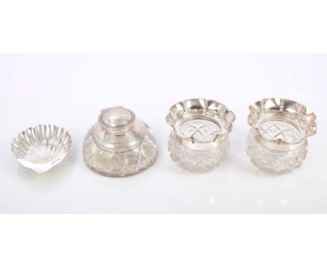 Late Victorian silver shell butter dish on three ball feet (Sheffield 1899), a silver mounted cut glass inkwell with engraved