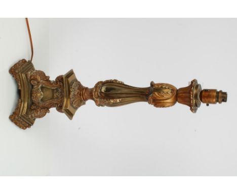Continental brass torchère-style lamp base, leaf capped column on triform bombé acanthus capped base and shaped platform, on 