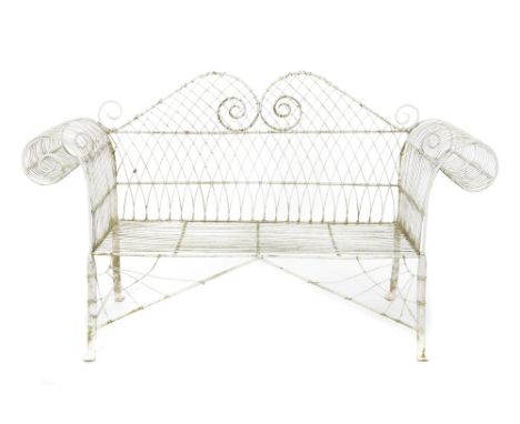 19th century iron wirework garden bench with undulating lattice back and overscroll arms on spread supports, 188cm wide