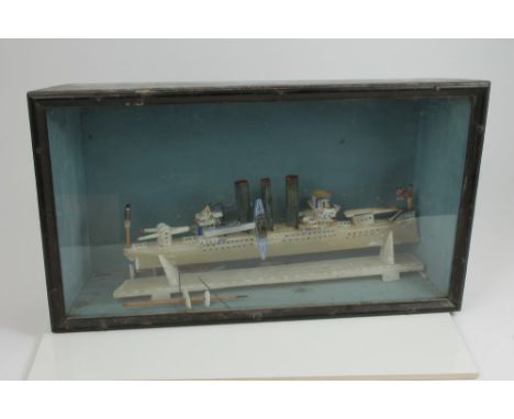 Very rare First World War carved alabaster ship diorama, the three-funnelled gun boat with British flags, crude figures and m