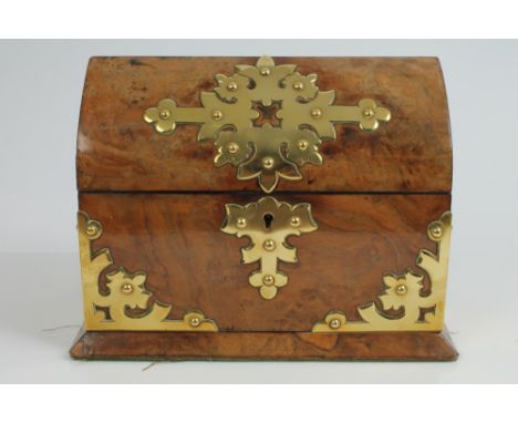 Victorian Gothic-style figured walnut and brass mounted tea caddy of domed rectangular form, on spread plinth with pierced st