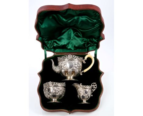 Fine quality Victorian three piece tea set comprising teapot of half-lobed cauldron form, with embossed rococo scroll and fol