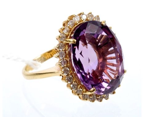 Gold (18ct) amethyst and diamond cocktail ring with a large oval mixed cut amethyst surrounded by a border of brilliant cut d