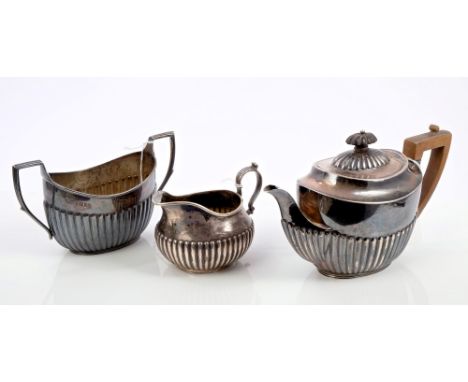 Composite three piece Victorian silver tea set, comprising teapot of half-fluted form, with engraved initial, fruitwood handl