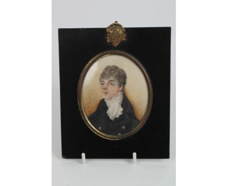 Early 19th century English School oval portrait miniature on ivory - a young man in black coat, in gilt metal mounted ebonise