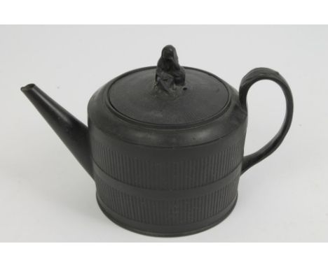 Early 19th century black basalt teapot and cover of squat cylindrical form, with widower knop and leaf-capped strap handle, w