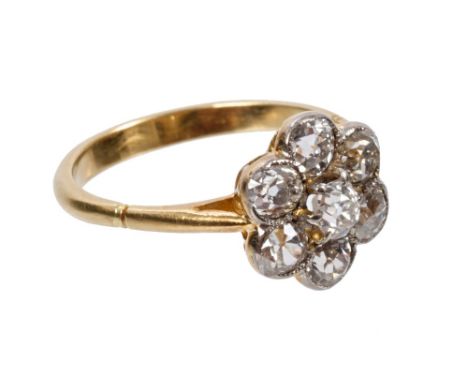 Edwardian diamond cluster ring with a flower-head cluster of seven old cut diamonds in millegrain setting, on gold shank.  Es