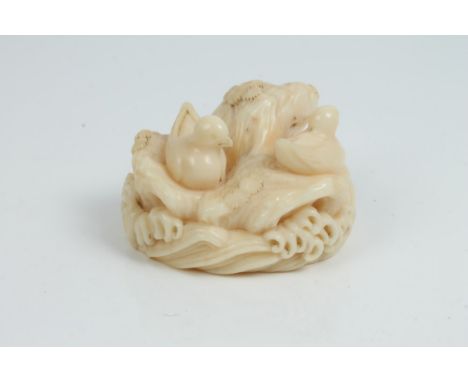 Late 19th century ivory netsuke, carved as birds roosting on a rocky outcrop with crashing waves below, 4cm wide CONDITION RE