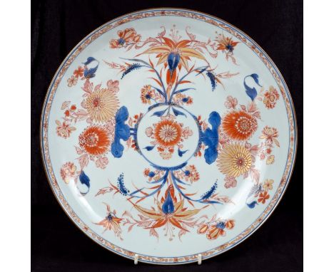 Set of three early 18th century Chinese Imari chargers, each with radiating exotic flower and leaf ornament within meander sc