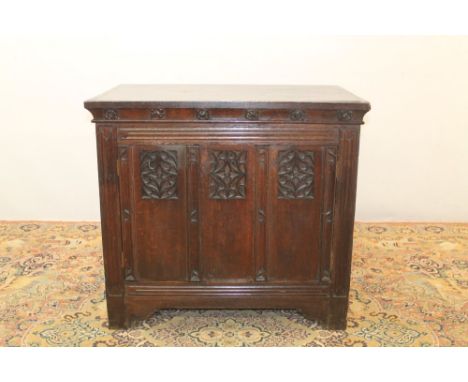 19th century Gothic oak umbry, the triple pierced fancy panel front with the cupboard doors enclosing shelves, on bracket fee