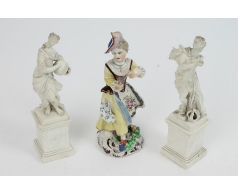 Mid-18th century English porcelain figure of a girl with painted floral sprigs and applied leaves and flowers to rococo scrol