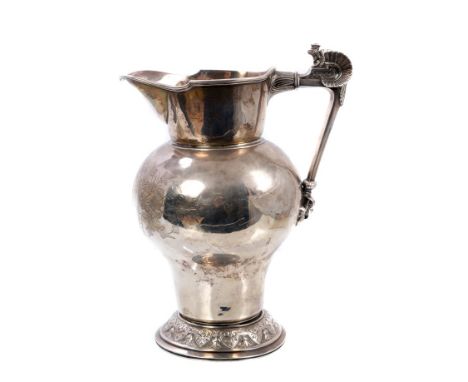 An interesting American sterling silver pitcher of inverted baluster form, with engraved foliate decoration, shaped top and s