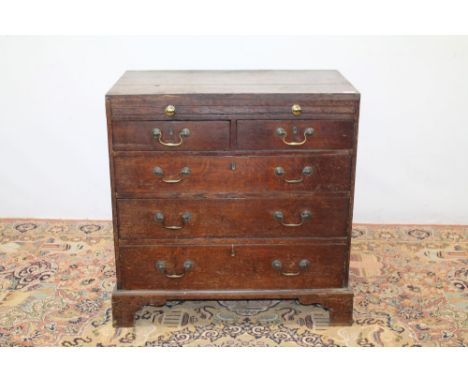 George III oak dressing chest of small proportions, with brushing slide and two short over three long graduated drawers, on b