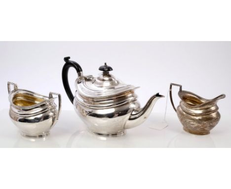 1920s silver three piece tea set comprising teapot of oval cauldron form, with reeded border, ebony scroll handle and domed h