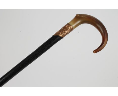 Early 20th century walking stick with ram's horn crook handle and ebony shaft, the gilt metal collar engraved with initials a