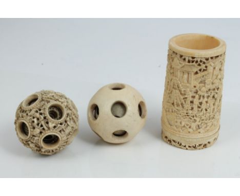 Carved Japanese ivory puzzle ball, typically relief carved and pierced with figures in landscapes, 6cm diameter, together wit