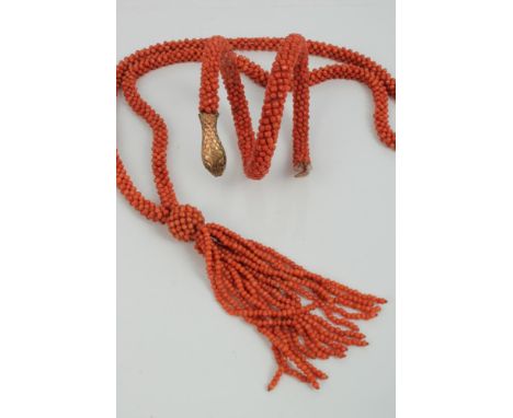 19th century snake bangle with coral beaded body and yellow metal terminals and a coral bead necklace with tassel drop CONDIT