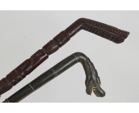 Chinese carved horn and ivory inset walking cane, the crook carved as a dragon's head with white metal mounted shaft, 84cm lo