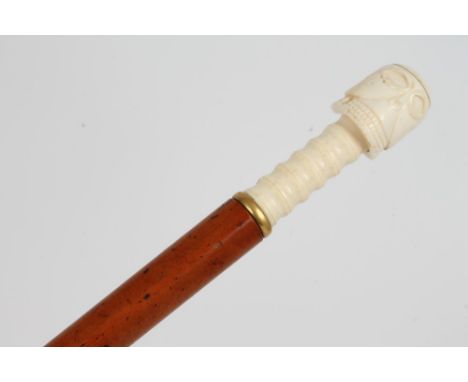 19th century cane with bone handle stylistically carved as a skull, on malacca shaft with brass ferrule, 100cm