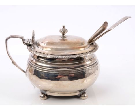 Large George III silver mustard pot of compressed cauldron form, with gadrooned border, scroll handle, domed hinged cover wit