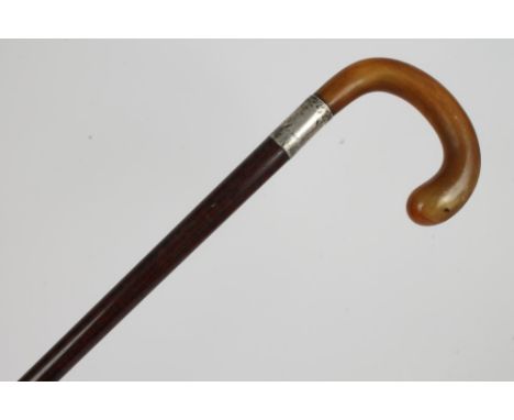 Early 20th century walking stick with rhinoceros horn crook handle and snakewood shaft, the silver collar engraved 'W. Eglint