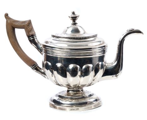 Late 18th / early 19th century silver teapot of half-lobed form, with band of reeded decoration and gadrooned border, carved 