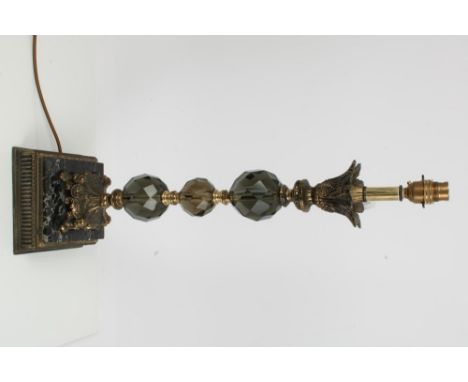 Decorative gilt metal and glass lamp with leaf capped facetted glass knop column on marble and tooled metal stepped square ba