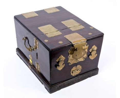 19th century Chinese padouk and brass mounted travelling dressing table box, on relief scroll carved plinth base, with hinged