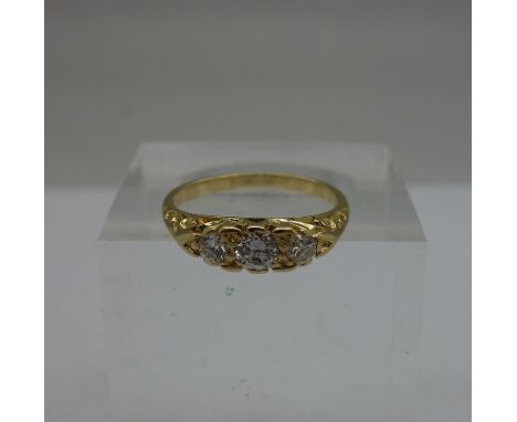 An 18ct gold and three stone diamond ring, weight 2.8g, size K