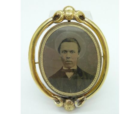A Victorian memorial swivel brooch with oval portrait