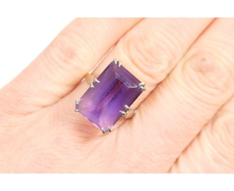 Amethyst dress ring, rectangular cut stone of approx. 17mm x 10mm, set in 18ct white and yellow gold, size Q/R, gross weight 