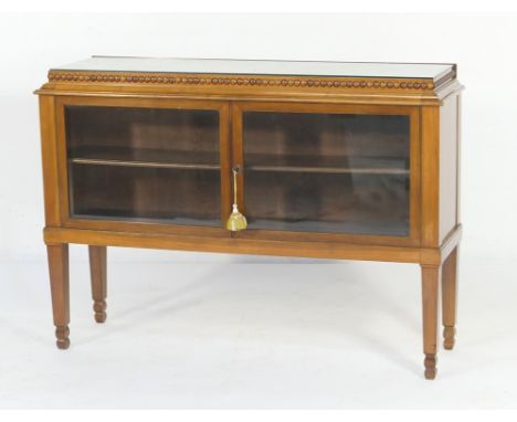 German walnut and glazed retailer's cabinet, having a beaded caddy style top with plate glass cover over two bevelled glass d