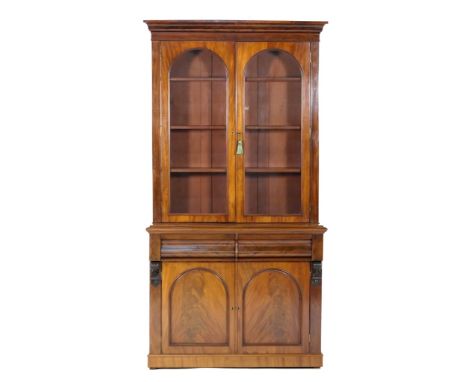 Victorian mahogany library bookcase, circa 1860-80, the top with an ogee moulded cornice over two arched glazed panel doors o