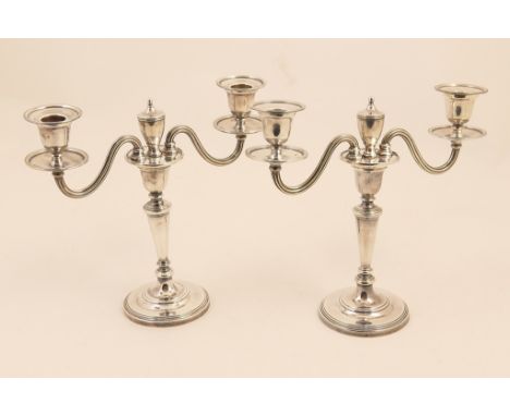 Pair of silver candelabra, maker R.C., London 1957, twin branch centred with an urn finial over a tapered column and reeded c