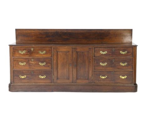 George III oak enclosed dresser, circa 1780-1800, having a board back three plank top with a moulded edge, over two recessed 