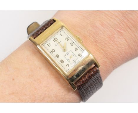 Vintage Cyma 9ct gold cased gent's wristwatch, circa 1946, tonneau shaped case enclosing a rectangular dial with Arabic numer