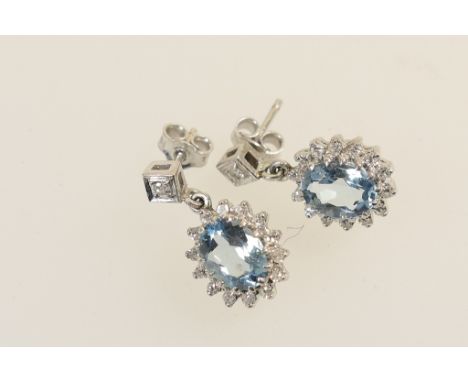 Pair of aquamarine and diamond cluster pendant earrings, the oval cut aqua approx. 11mm x 6mm, bordered with tiny brilliants,