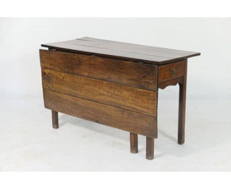 Provincial oak drop leaf table, late 18th Century, having a plank top with a single three plank drop leaf supported on a swin