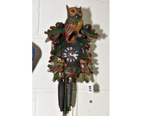 A MID TWENTIETH CENTURY CUCKOO CLOCK with pendulum and weights, made in Germany height approximately 28cm