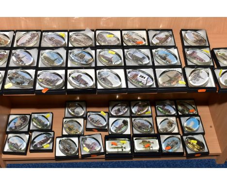 A COLLECTION OF FORTY SEVEN BOXED OVAL GLASS PAPERWEIGHTS, each with a print to the base, mostly scenes of parish churches, w