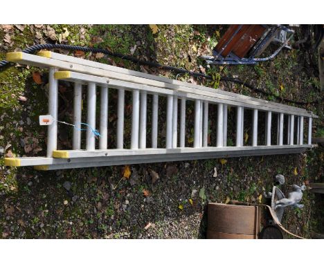 AN ALUMINIUM DOUBLE EXTENSION LADDER with twelve rungs to each 340cm section