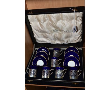 A CASED SET OF SIX EARLY 20TH CENTURY AYNSLEY COFFEE CANS IN SILVER SLEEVES AND SAUCERS, blue and gilt, the silver with geome