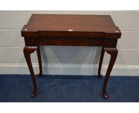 A REPRODUCTION MAHOGANY CONCERNTINA CARD TABLE, double fold over top enclosing an olive green leather insert, and a games boa